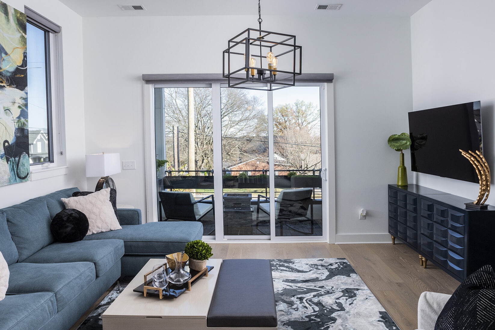 Custom lighting fixtures and light treatments in living room spaces.